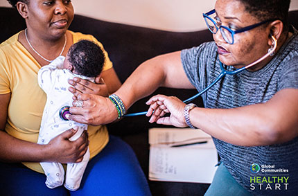 Doula listening for baby's heartbeat