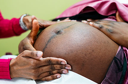 Black woman's pregnant belly